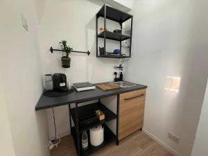 a bathroom with a sink and a counter with a sink at Maison Circe - Boutique Apartment in Latina