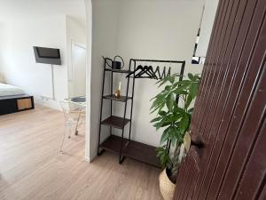 a room with a plant and a room with a bed at Maison Circe - Boutique Apartment in Latina
