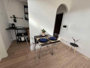 a dining table with blue plates on it in a room at Maison Circe - Boutique Apartment in Latina +7 photos