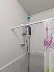 a shower with a shower curtain in a bathroom at WALK-UP Cozy Angel's 8 Pad at Plumera near Mactan Airport in Lapu Lapu City