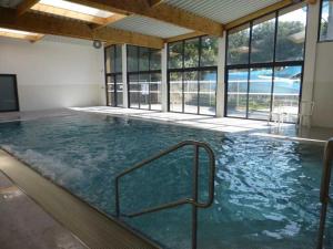 a large indoor swimming pool with glass windows at Camping 4 étoiles - Piscine - ccaaeah in La Baule