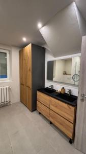 a bathroom with a sink and a wooden cabinet at Charmante maison alsacienne proche Europa Park et Marchés de Noël in Ohnenheim +11 photos