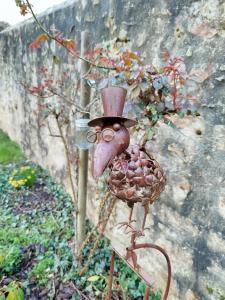 a bird in a top hat on a stand at Château Besson in Montluçon