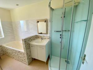 a bathroom with a tub and a sink and a shower at Maison à la Campagne à Melgven in Melgven +21 photos