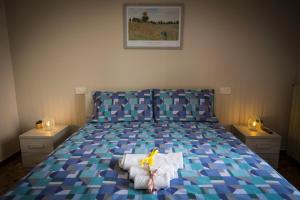 a bedroom with a bed with a doll sitting on a pillow at B&B Dr De Masi in Pietrelcina