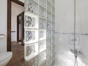 a bathroom with a shower with glass blocks on the wall at Cubo's Casa Rural La Albahaca de Libar in Jimera de Líbar +41 photos