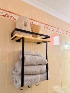 a pile of towels on a shelf in a bathroom at Marine's apartments in Symi +27 photos