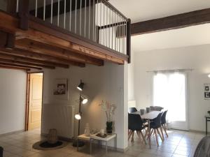a living room with a staircase and a table at Maison de vacances Olonzac in Olonzac