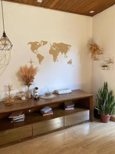 a room with a wooden table with a world map on the wall at Hostel Amor por SP - Brás - Expo Center Norte - Feira da Madrugada in São Paulo