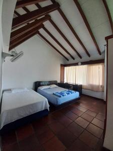a room with two beds and a couch in it at El Linaje Home in Cali +12 photos