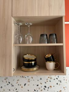 a wooden cabinet with dishes and glasses on it at 1 кімн квартира ТРоПіКі тихий центр in Chernihiv +10 photos