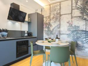 a kitchen and dining room with a table and chairs at Appartamenti Pamar in Civitanova Marche