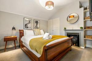 ein Schlafzimmer mit großem Bett und Kamin in der Unterkunft Mills Cottage - 1 parking space in Henley on Thames