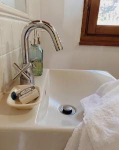 a sink with a faucet and a soap holder at Vergel San Pedro in Torremenga +11 photos