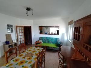 a living room with a table and a couch at Casa Francis in Aljezur +8 photos