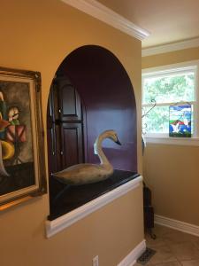a painting of a swan in a niche in a room at Magical Bayfrnt Home, Pier, Beach, Fossils, Trails in Port Republic