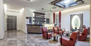 a lobby with a table and chairs and a counter at Hotel Theater Belgrade in Belgrade