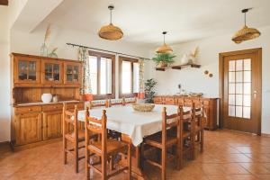 a kitchen with a table and chairs in a room at Villa Lucia in Alghero