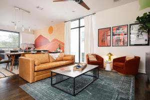 a living room with a couch and a table at Space City - Prof Design, Game Room, King BD in Houston