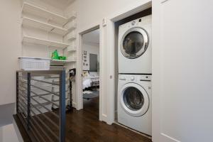 a laundry room with a washer and dryer at Space City - Prof Design, Game Room, King BD in Houston