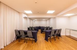 a conference room with tables and chairs in it at B&B HOTEL Rio Copacabana Forte in Rio de Janeiro