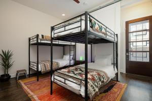 a bedroom with two bunk beds in a room at Space City - Prof Design, Game Room, King BD in Houston