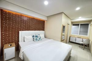Vuode tai vuoteita majoituspaikassa Hotel Lengkong 2