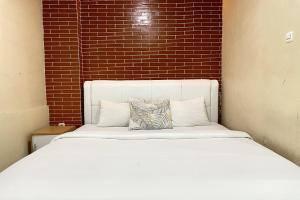 Vuode tai vuoteita majoituspaikassa Hotel Lengkong 2