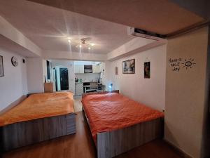 a bedroom with two beds and a kitchen at Darvik appartement in Ohrid