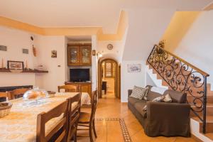 a living room with a table and a couch at Villa Gea in Praiano
