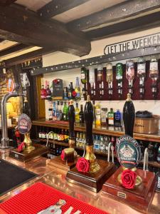 a bar with bottles of alcohol on a counter at Oakrooms in Swayfield