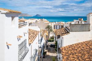 an aerial view of a town with white buildings and the ocean at Casa Brisa in Altea