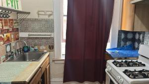 a kitchen with a sink and a stove at SF Travelers Inn in San Francisco