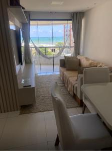 a living room with a couch and a tv at Palazzo di Milano in Ilhéus