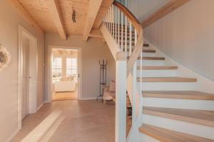 a winding staircase in a home with wooden ceilings at Watermark Usedom - Premium Ferienhaus direkt am Wasser mit eigener Badestelle in Rankwitz +33 photos