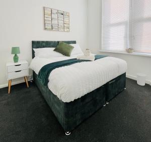 a bedroom with a large bed with a green headboard at Francis Avenue in Portsmouth