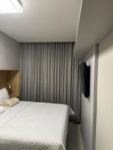a bedroom with a large white bed and curtains at Gerizim in Vila Velha +43 photos