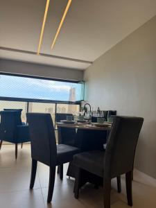 a dining room with chairs and a table and a window at Gerizim in Vila Velha +29 photos