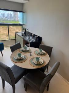 a dining room with a table and chairs at Gerizim in Vila Velha