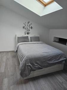 a bedroom with a large bed in a white room at maison 3 chambre entre metz et nancy in Rembercourt-sur-Mad