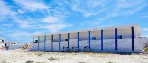 a building with three bikes parked in front of it at Stabilimento Lido Burrone in Favignana