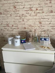 a white counter with toiletries and water bottles on it at Studio Vieux Port Chez Fanette in Marseille