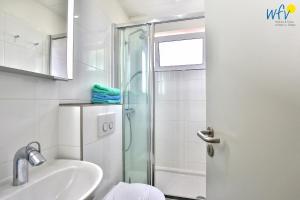 a bathroom with a shower and a sink at Residenz am Alten Leuchtturm Ferienwohnung 7 in Wangerooge +16 photos