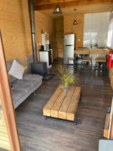 a living room with a couch and a table at Vistaranco Cabaña in Lago Ranco