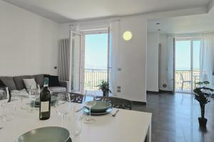 a living room with a table with wine glasses at Double Sea View Design Wi-Fi Parking AC in Fermo