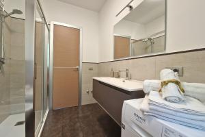 a bathroom with a sink and a shower with towels at Double Sea View Design Wi-Fi Parking AC in Fermo +36 photos