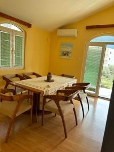 a dining room with a table and chairs at Galicia Hills in Bečići