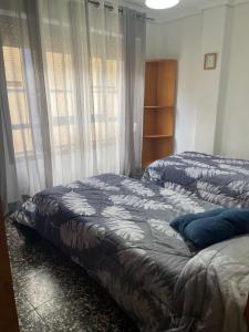 A bed or beds in a room at APARTAMENTO TURISTICO MILLAN
