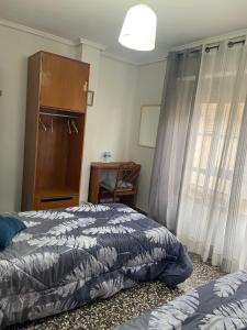 A bed or beds in a room at APARTAMENTO TURISTICO MILLAN
