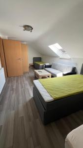 a living room with a bed and a couch at Ferienwohnung in Wesel
